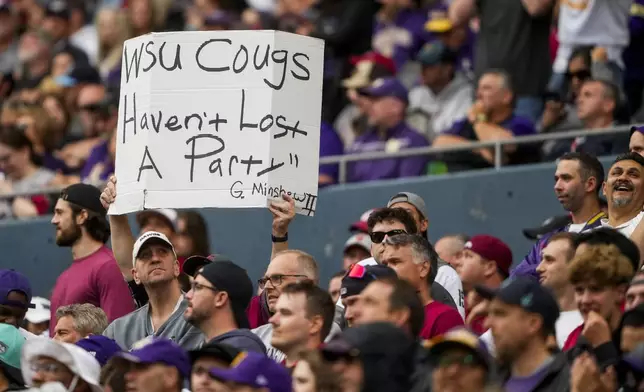 A Washington State fan holds up a sign during the second half of an NCAA college football game against Washington, Saturday, Sept. 14, 2024, in Seattle. Washington State won 24-19. (AP Photo/Lindsey Wasson)