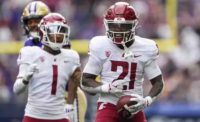 Washington State running back Wayshawn Parker (21) reacts to making a catch against Washington during the first half of an NCAA college football game Saturday, Sept. 14, 2024, in Seattle. (AP Photo/Lindsey Wasson)