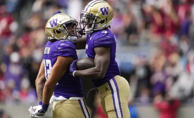 Washington wide receiver Giles Jackson, right, celebrates his touchdown with wide receiver Denzel Boston (12) against Washington State during the first half of an NCAA college football game Saturday, Sept. 14, 2024, in Seattle. (AP Photo/Lindsey Wasson)