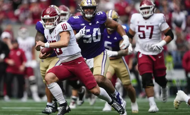 Washington State quarterback John Mateer (10) runs for a touchdown against Washington defensive tackle Sebastian Valdez (50) during the first half of an NCAA college football game Saturday, Sept. 14, 2024, in Seattle. (AP Photo/Lindsey Wasson)