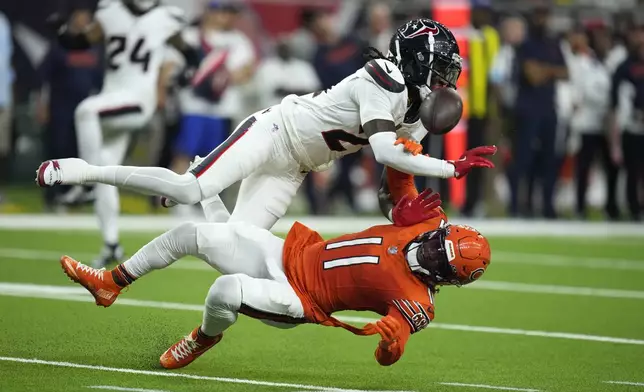 Chicago Bears wide receiver DeAndre Carter (11) collides with Houston Texans safety Calen Bullock while attempting to catch a pass during the first half of an NFL football game Sunday, Sept. 15, 2024, in Houston. Bullock was flagged for defensive pass interference on the play. (AP Photo/Eric Christian Smith)