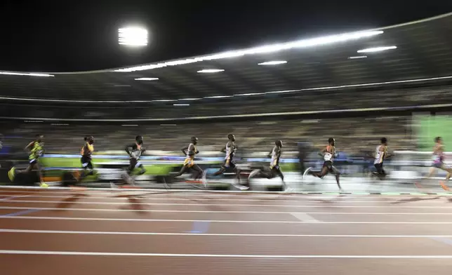 Athletes compete in the men's 5000 meters during the Diamond League final 2024 athletics meet in Brussels, Friday, Sept. 13, 2024. (AP Photo/Frederic Sierakowski)