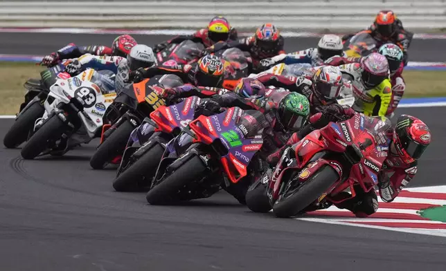 MotoGP rider Francesco Bagnaia of Italy leads into a curve during the first lap of the San Marino Motorcycle Grand Prix at the Misano circuit in Misano Adriatico, Italy, Sunday, Sept. 8, 2024. (AP Photo/Antonio Calanni)