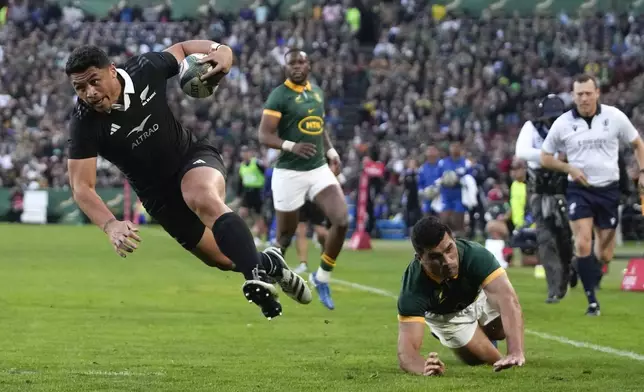 New Zealand's Caleb Clarke runs to score a try during a rugby championship test match between South Africa and New Zealand at Ellis Park stadium in Johannesburg, South Africa, Saturday, Aug. 31, 2024. (AP Photo/Themba Hadebe)