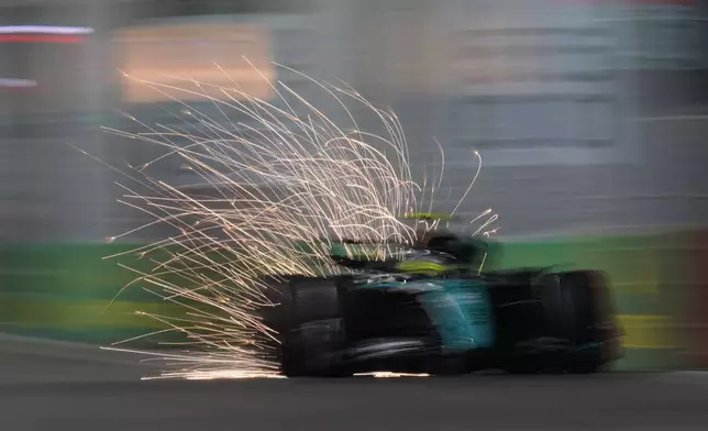 Mercedes driver Lewis Hamilton of Britain steers his car during the qualifying session of the Singapore Formula One Grand Prix at the Marina Bay Street Circuit, in Singapore, Saturday, Sept. 21, 2024. (AP Photo/Vincent Thian)