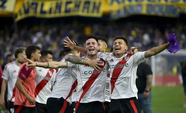 River Plate players celebrate after their team defeated Boca Juniors in an Argentine soccer league match at La Bombonera stadium in Buenos Aires, Argentina, Saturday, Sept. 21, 2024.(AP Photo/Gustavo Garello)