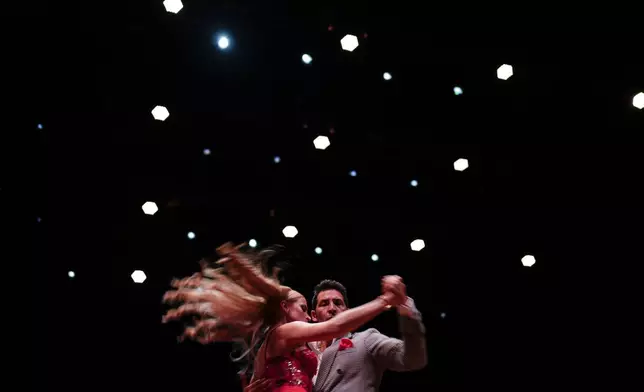 Maxi Copello and Karu Terenzio from Entre Rios, Argentina, dance during the salon category finals of the World Tango Championship in Buenos Aires, Argentina, Tuesday, Aug. 27, 2024. (AP Photo/Natacha Pisarenko)