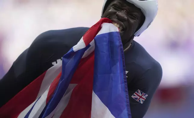 Britain's Marcus Perrineau Daley celebrates after winning the silver medal in the men's 100m T52 final during the 2024 Paralympics, Friday, Sept. 6, 2024, in Paris, France. (AP Photo/Thibault Camus)