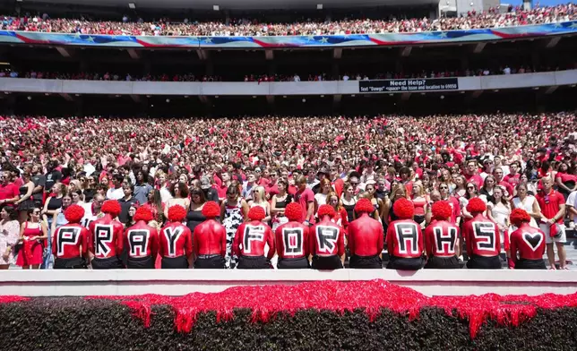 Fans observe a moment of silence for victims of Wednesday's school shooting at Apalachee High School before an NCAA college football game between Tennessee Tech and Georgia Saturday, Sept. 7, 2024, in Athens, Ga. (AP Photo/John Bazemore)