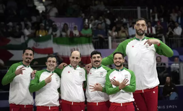 Iran players celebrate after winning the men's Sitting Volleyball Gold Medal Match against Bosnia and Herzegovina, at the 2024 Paralympics, Friday, Sept. 6, 2024, in Paris, France. (AP Photo/Christophe Ena)