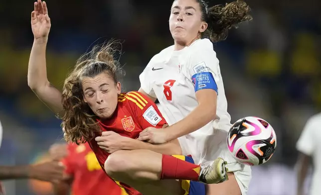 Spain's Lucia Corrales, left and Canada's Florianne Jourde fight for the ball during a U-20 Women's World Cup round of sixteen soccer match in Cali, Colombia, Wednesday, Sept. 11, 2024. (AP Photo/Dolores Ochoa)