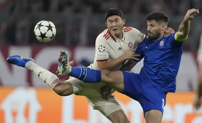 Bayern's Kim Min-jae, left, vies for the ball with Dinamo's Bruno Petkovic during the Champions League opening phase soccer match between Bayern Munich and GNK Dinamo at the Allianz Arena in Munich, Germany, Tuesday, Sept. 17, 2024. (AP Photo/Matthias Schrader)