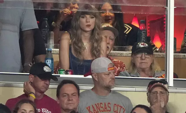 Taylor Swift watches from a suite during the second half of an NFL football game between the Kansas City Chiefs and the Baltimore Ravens Thursday, Sept. 5, 2024, in Kansas City, Mo. (AP Photo/Charlie Riedel)