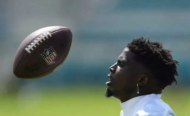 Miami Dolphins wide receiver Tyreek Hill eyes a ball during a team practice session, Wednesday, Sept. 11, 2024, in Miami Gardens, Fla. (AP Photo/Rebecca Blackwell)