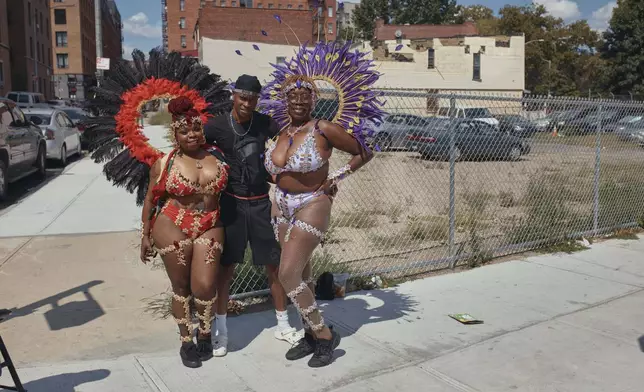 Revelers pose for a photograph during the West Indian Day Parade on Monday, Sept. 2, 2024, in the Brooklyn borough of New York. (AP Photo/Andres Kudacki)