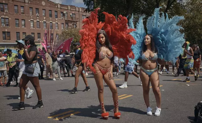 Revelers gather during the West Indian Day Parade on Monday, Sept. 2, 2024, in the Brooklyn borough of New York. (AP Photo/Andres Kudacki)