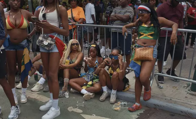 Revelers gather during the West Indian Day Parade on Monday, Sept. 2, 2024, in the Brooklyn borough of New York. (AP Photo/Andres Kudacki)