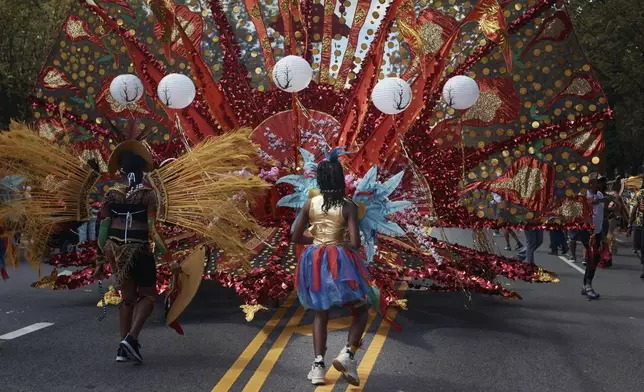 Revelers march during the West Indian Day Parade on Monday, Sept. 2, 2024, in the Brooklyn borough of New York. (AP Photo/Andres Kudacki)