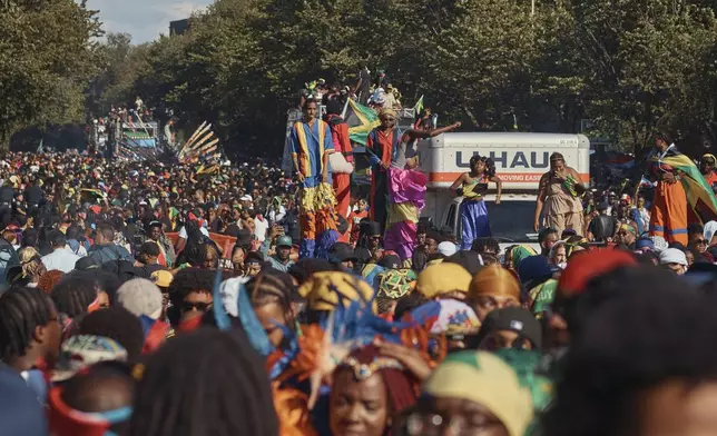 Revelers march at the intersection of Franklin Avenue and Eastern Parkway during the West Indian Day Parade on Monday, Sept. 2, 2024, in the Brooklyn borough of New York. (AP Photo/Andres Kudacki)