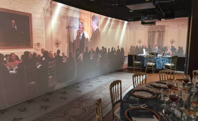 A 3D interactive room with dinner tables, music and videos of State Dinners at the White House, shown at The People's House exhibit, Monday, Sept. 16, 2024 in Washington. (AP Photo/Jose Luis Magana)