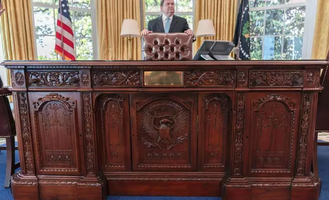 White House Historical Association President Stewart McLaurin tours members of the media in a replica of the Oval Office as is today, shown at The People's House exhibit, Monday, Sept. 16, 2024 in Washington. (AP Photo/Jose Luis Magana)