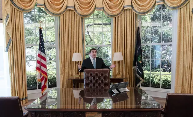 White House Historical Association President Stewart McLaurin tour members of the media in a replica of the Oval Office as is today, shown at The People's House exhibit, Monday, Sept. 16, 2024 in Washington. (AP Photo/Jose Luis Magana)