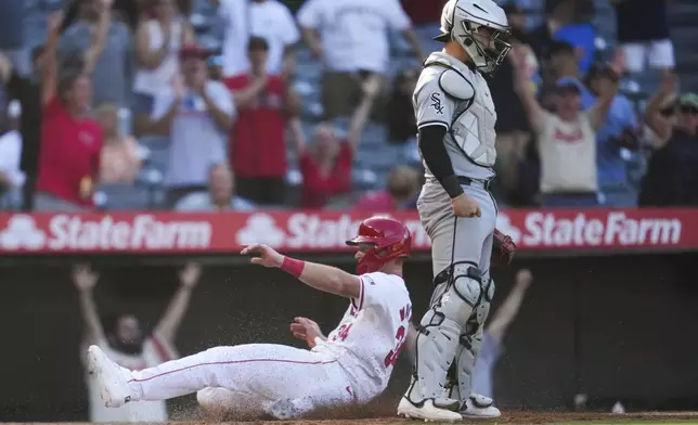 Los Angeles Angels' Eric Wagaman (34) scores off of a walk-off single hit by Jordyn Adams during the thirteenth inning of a baseball game against the Chicago White Sox in Anaheim, Calif., Wednesday, Sept. 18, 2024. The Angels won 4-3. (AP Photo/Ashley Landis)