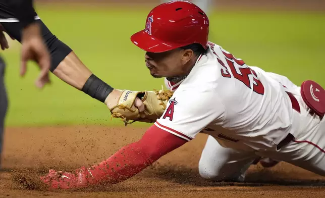 Los Angeles Angels' Gustavo Campero, right, is tagged out at first by Chicago White Sox first baseman Gavin Sheets after he rounded first for a single and tried to dive back during the third inning of a baseball game, Tuesday, Sept. 17, 2024, in Anaheim, Calif. (AP Photo/Mark J. Terrill)