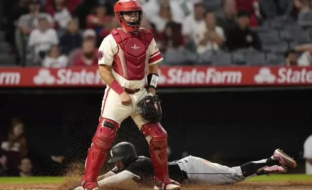 Chicago White Sox's Jacob Amaya, below, scores on a single by Luis Robert Jr. as Los Angeles Angels catcher Matt Thaiss stands at the plate during the second inning of a baseball game, Monday, Sept. 16, 2024, in Anaheim, Calif. (AP Photo/Mark J. Terrill)