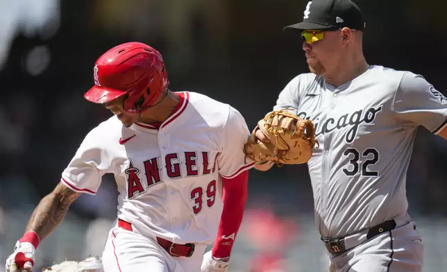 Chicago White Sox first baseman Gavin Sheets (32) tags out Los Angeles Angels' Jordyn Adams (39) at first base during the third inning of a baseball game in Anaheim, Calif., Wednesday, Sept. 18, 2024. (AP Photo/Ashley Landis)