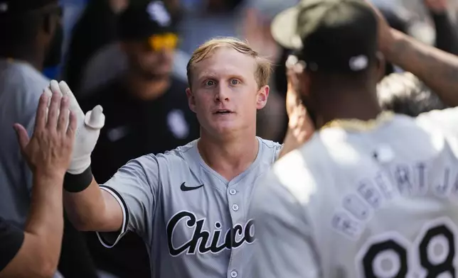 Chicago White Sox designated hitter Andrew Vaughn celebrates in the dugout after hitting a home run during the fourth inning of a baseball game against the Los Angeles Angels in Anaheim, Calif., Wednesday, Sept. 18, 2024. (AP Photo/Ashley Landis)