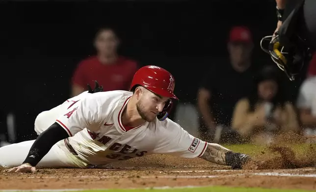 Los Angeles Angels' Charles Leblanc scores on a single by Taylor Ward during the third inning of a baseball game against the Chicago White Sox, Tuesday, Sept. 17, 2024, in Anaheim, Calif. (AP Photo/Mark J. Terrill)