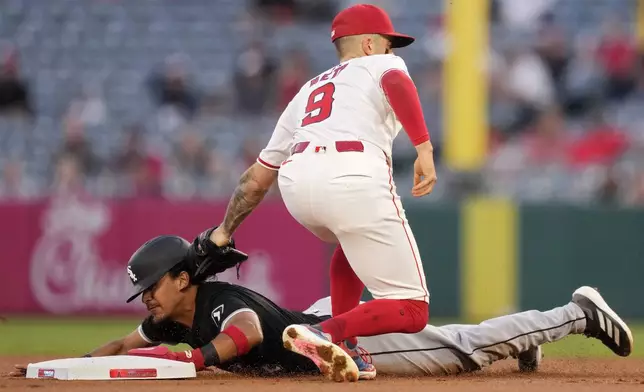 Los Angeles Angels shortstop Zach Neto, top, tags out Chicago White Sox's Nicky Lopez as Lopez tries to steal second during the first inning of a baseball game, Tuesday, Sept. 17, 2024, in Anaheim, Calif. (AP Photo/Mark J. Terrill)