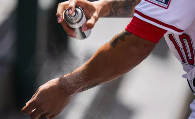 Los Angeles Angels shortstop Jack López applies sunscreen before a baseball game against the Chicago White Sox in Anaheim, Calif., Wednesday, Sept. 18, 2024. (AP Photo/Ashley Landis)