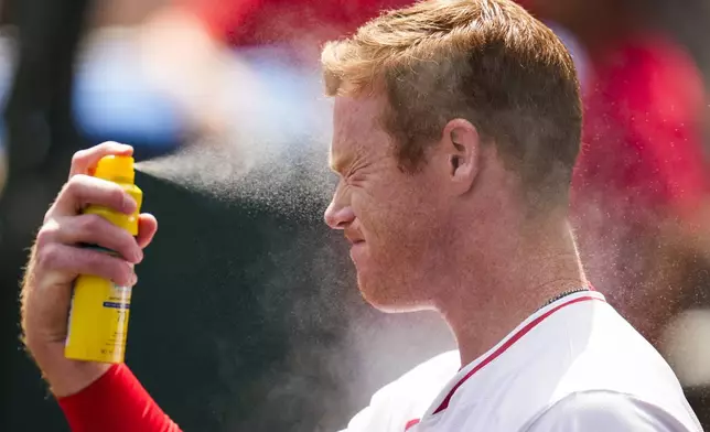 Los Angeles Angels third baseman Eric Wagaman applies sunscreen before a baseball game against the Chicago White Sox in Anaheim, Calif., Wednesday, Sept. 18, 2024. (AP Photo/Ashley Landis)