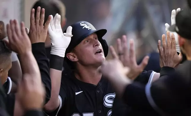 Chicago White Sox's Andrew Vaughn is congratulated by teammates in the dugout after hitting a solo home run during the first inning of a baseball game against the Los Angeles Angels, Monday, Sept. 16, 2024, in Anaheim, Calif. (AP Photo/Mark J. Terrill)