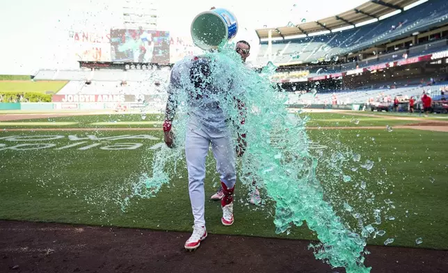 Los Angeles Angels' Jordyn Adams is doused after a walk-off single to win 4-3 against the Chicago White Sox in a baseball game in Anaheim, Calif., Wednesday, Sept. 18, 2024. (AP Photo/Ashley Landis)