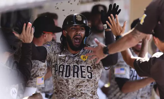 San Diego Padres' Fernando Tatis Jr. celebrates in the dugout after hitting a solo home run against the Chicago White Sox in the eighth inning of a baseball game, Sunday, Sept. 22, 2024, in San Diego. (AP Photo/Derrick Tuskan)