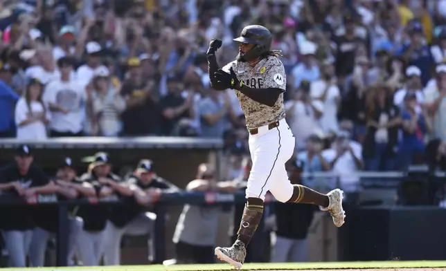 San Diego Padres' Fernando Tatis Jr. celebrates while heading to home plate after hitting a solo home run against the Chicago White Sox in the eighth inning of a baseball game, Sunday, Sept. 22, 2024, in San Diego. (AP Photo/Derrick Tuskan)