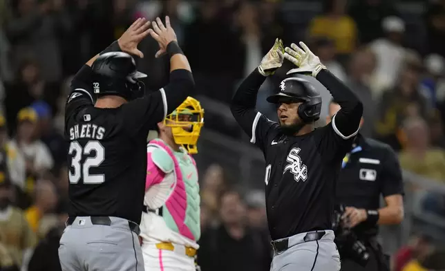 Chicago White Sox's Lenyn Sosa, right, celebrates his two-run home run with teammate Gavin Sheets (32) during the ninth inning of a baseball game against the San Diego Padres, Friday, Sept. 20, 2024, in San Diego. (AP Photo/Gregory Bull)