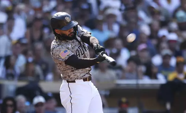 San Diego Padres' Fernando Tatis Jr. hits a solo home run against the Chicago White Sox in the eighth inning of a baseball game, Sunday, Sept. 22, 2024, in San Diego. (AP Photo/Derrick Tuskan)