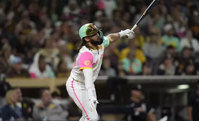 San Diego Padres' Fernando Tatis Jr. watches his walk off double during the tenth inning of a baseball game against the Chicago White Sox Friday, Sept. 20, 2024, in San Diego. The Padres won, 3-2. (AP Photo/Gregory Bull)