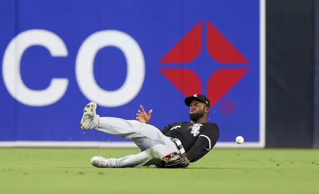 Chicago White Sox center fielder Luis Robert Jr. is unable to handle a double hit by San Diego Padres' Jurickson Profar during the fifth inning of a baseball game, Saturday, Sept. 21, 2024, in San Diego. (AP Photo/Ryan Sun)