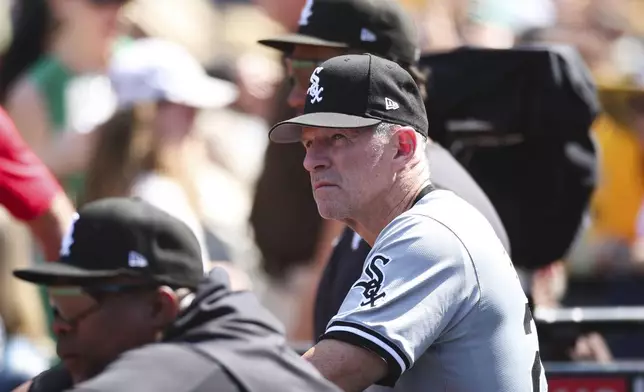 Chicago White Sox bench coach Doug Sisson, right, looks on from the dugout during a baseball game against the San Diego Padres, Sunday, Sept. 22, 2024, in San Diego. (AP Photo/Derrick Tuskan)