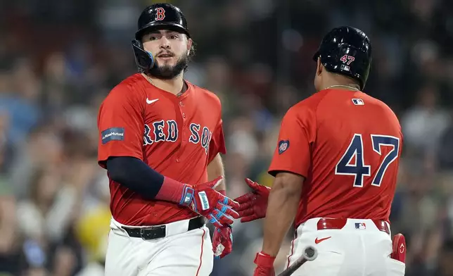 Boston Red Sox's Wilyer Abreu celebrates with Enmanuel Valdez (47) after scoring on a single by Triston Casas during the fourth inning of a baseball game against the Chicago White Sox, Friday, Sept. 6, 2024, in Boston. (AP Photo/Michael Dwyer)