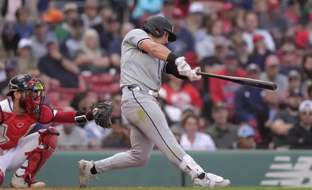 Chicago White Sox's Dominic Fletcher hits a one-run double in front of Boston Red Sox catcher Connor Wong, left, allowing Bryan Ramos to score in the ninth inning of a baseball game , Sunday, Sept. 8, 2024, in Boston. (AP Photo/Steven Senne)