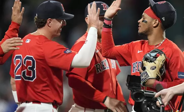 Boston Red Sox's Ceddanne Rafaela, right, celebrates with Romy Gonzalez (23) after defeating the Chicago White Sox in a baseball game, Friday, Sept. 6, 2024, in Boston. (AP Photo/Michael Dwyer)