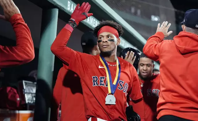 Boston Red Sox's Ceddanne Rafaela celebrates his two-run home run that also drove in Enmanuel Valdez, behind right, during the seventh inning of a baseball game against the Chicago White Sox, Friday, Sept. 6, 2024, in Boston. (AP Photo/Michael Dwyer)