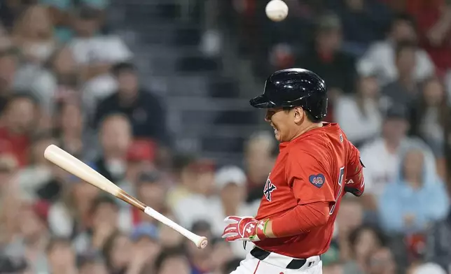 Boston Red Sox's Masataka Yoshida is hit by a pitch during the sixth inning of a baseball game against the Chicago White Sox, Friday, Sept. 6, 2024, in Boston. (AP Photo/Michael Dwyer)