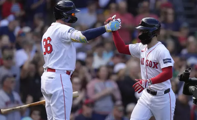 Boston Red Sox's Connor Wong, right, is welcomed by Triston Casas, left, as he scores on his home run in the second inning of a baseball game, Sunday, Sept. 8, 2024, in Boston. (AP Photo/Steven Senne)